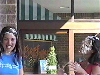 Two girls pie each other