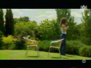 Two girls playing with a waterhose.