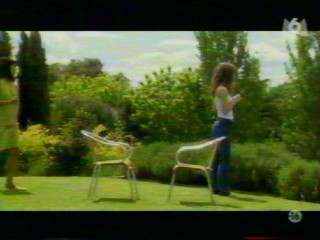 Two girls playing with a waterhose.