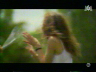 Two girls playing with a waterhose.