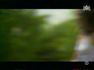 Two girls playing with a waterhose.