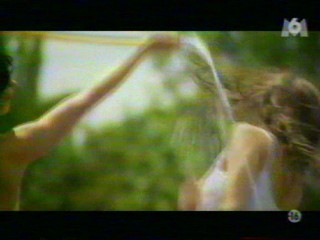 Two girls playing with a waterhose.